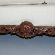 Three-seater canapé carved from solid walnut with claw feet.