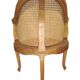 Armchair in solid oak with caning and a central leg (known as couillard), 89x68cm.