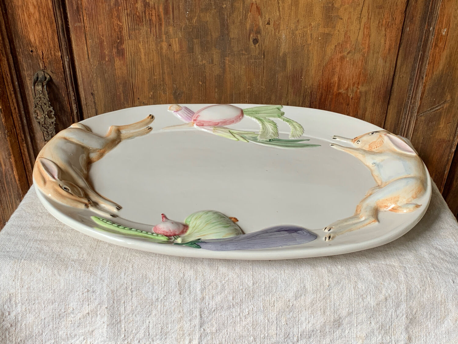 Very large serving dish with hares and vegetables.