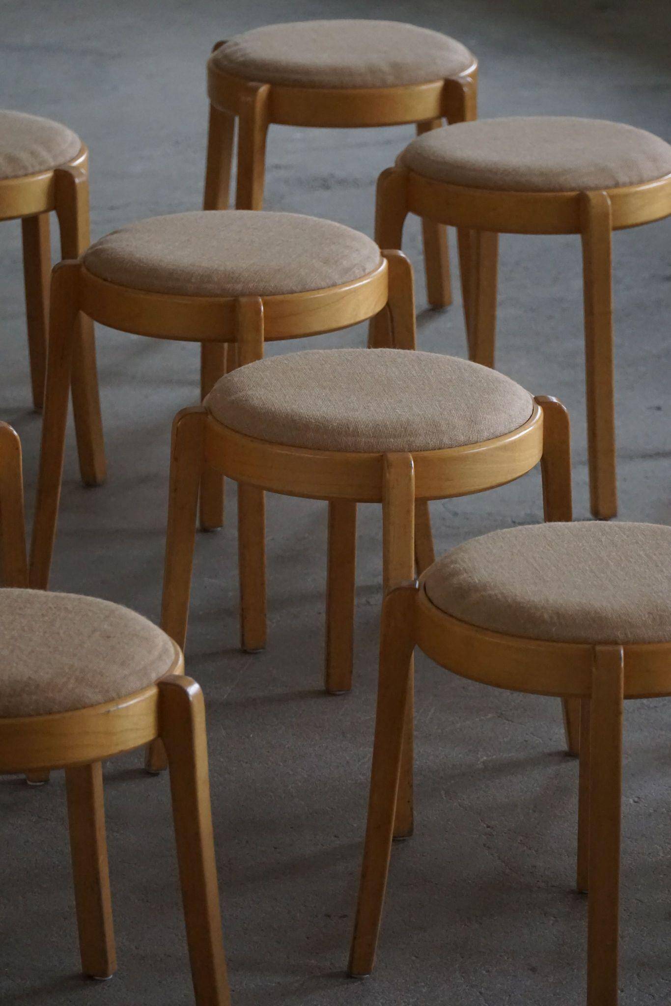 Set of 14 modern Swedish stackable stools in birch and hessian, 1980s.