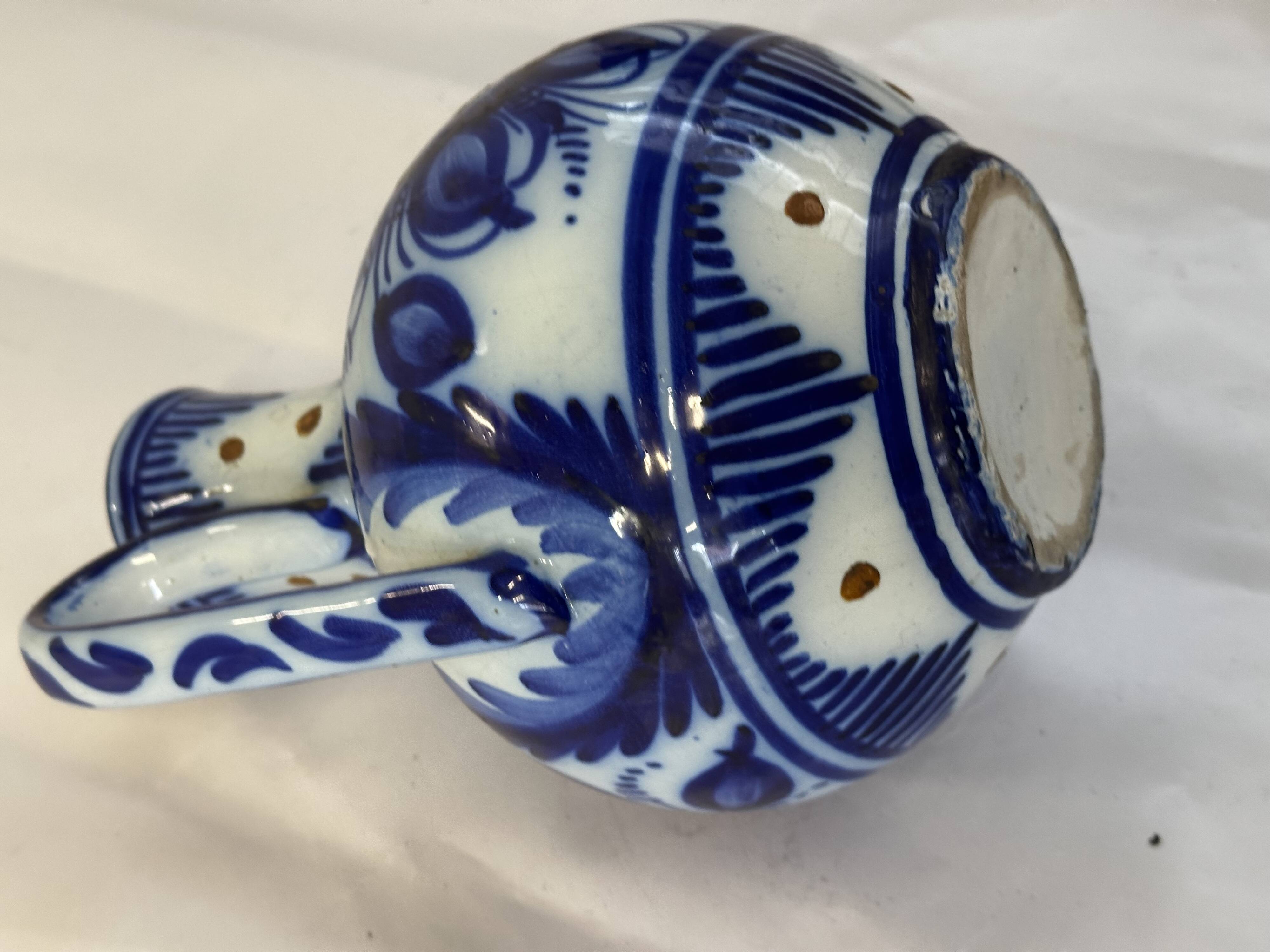 Glazed ceramic carafe with floral decoration