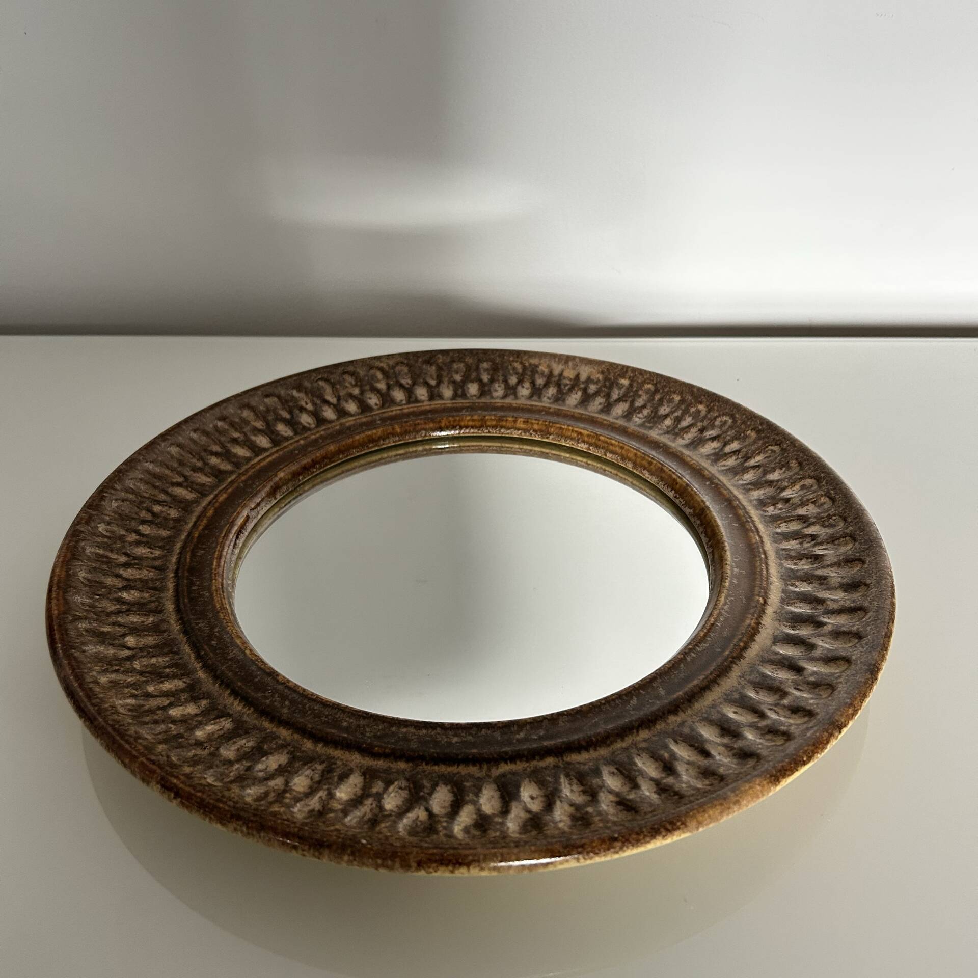 Chiselled stone mirror