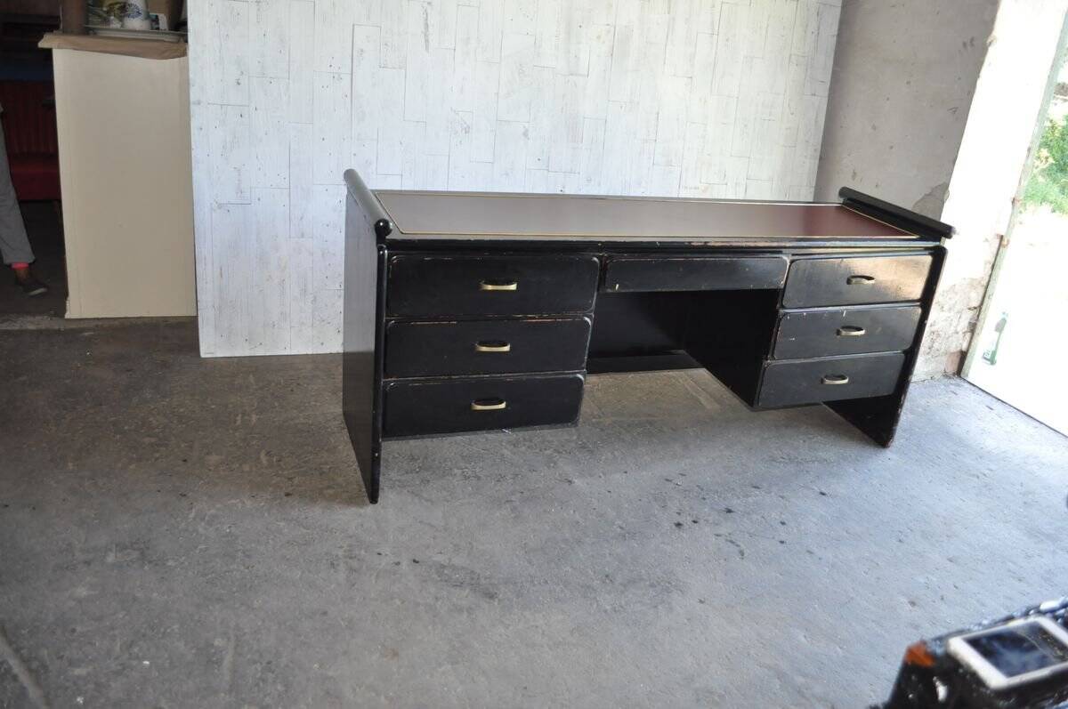 Hungarian Art Deco desk in black painted wood with a brown top and metal handles.