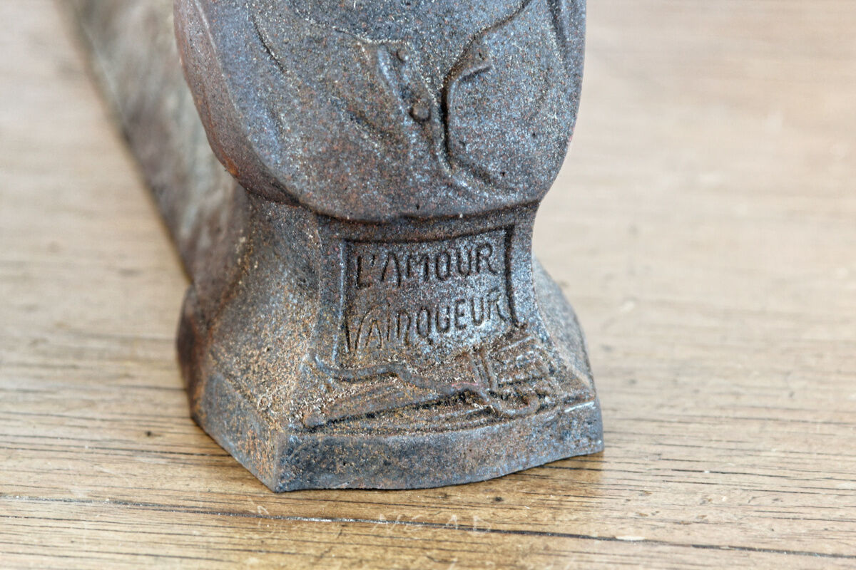 Pair of cast iron chenets, Love victorious