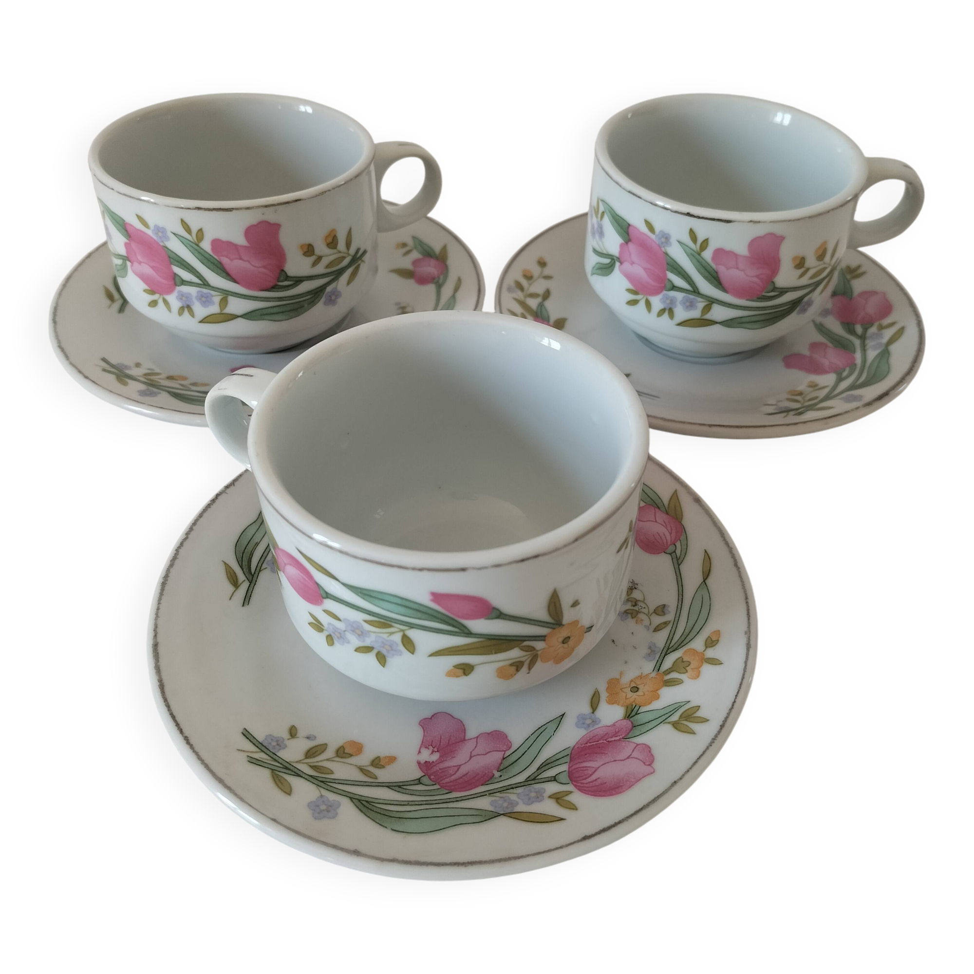 Trio of floral porcelain cups and saucers