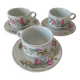 Trio of floral porcelain cups and saucers