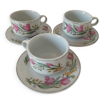Trio of floral porcelain cups and saucers