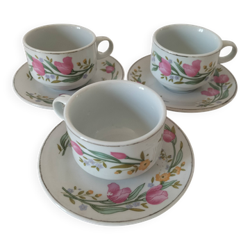 Trio of floral porcelain cups and saucers