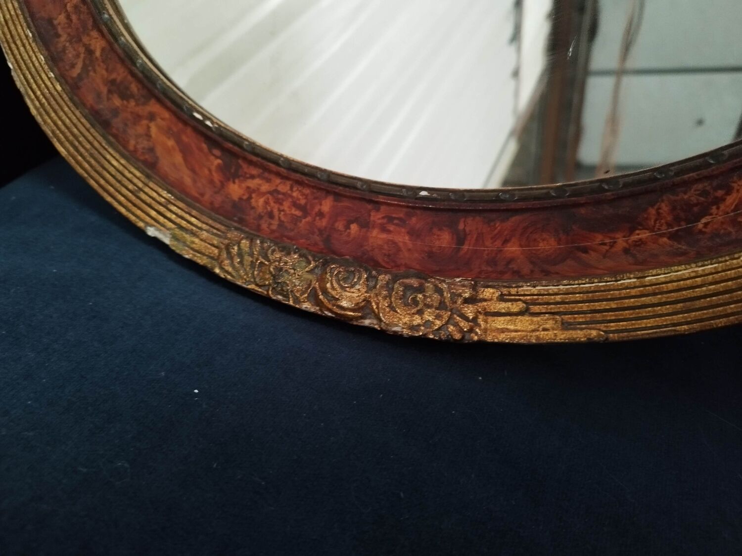 Golden oval art deco mirror