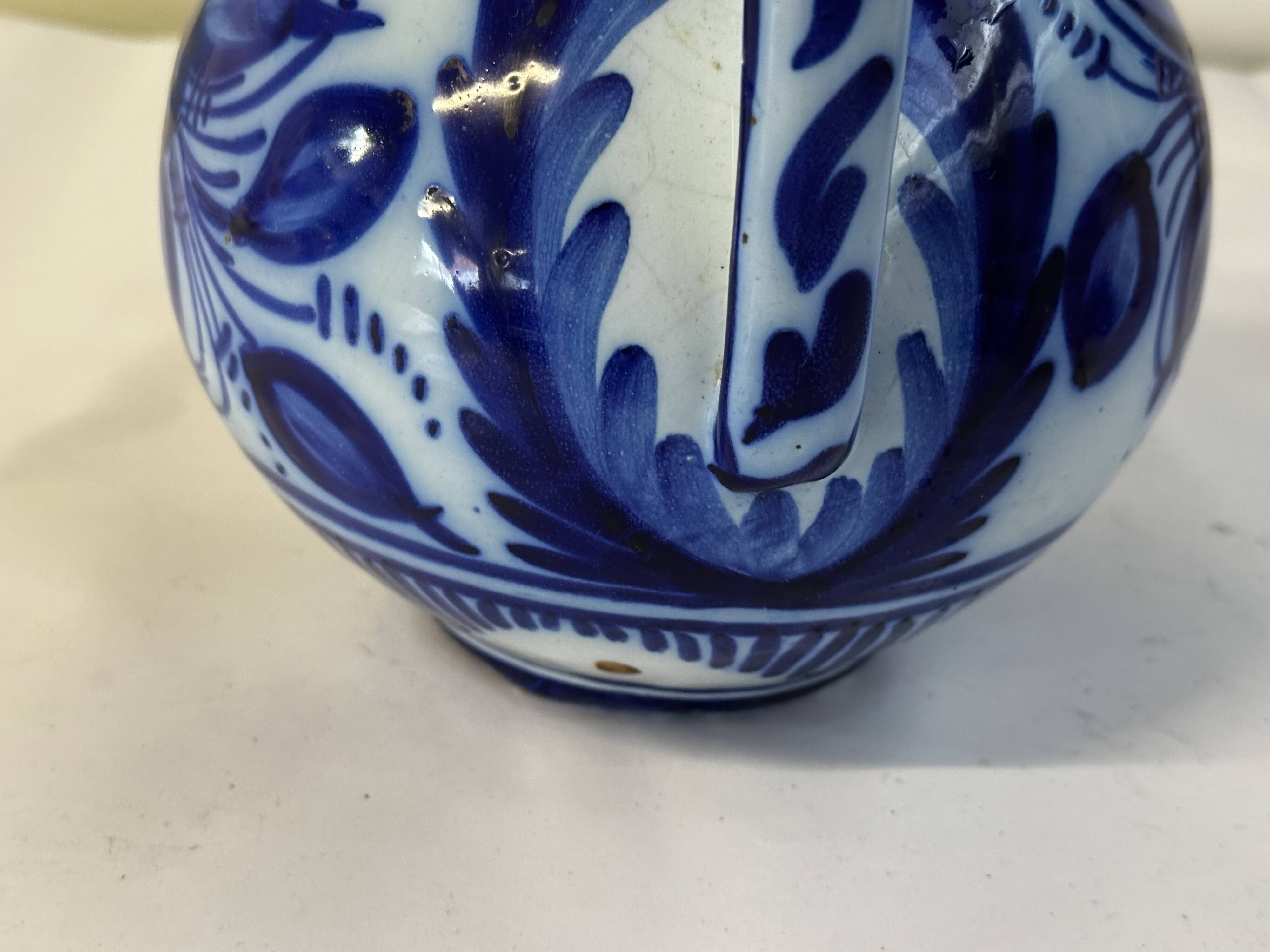 Glazed ceramic carafe with floral decoration