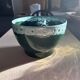 Green cache pot with a foam trim.