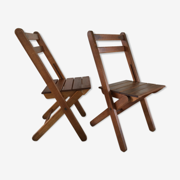 Pair of folding chairs over a wood fire