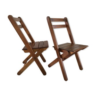 Pair of folding chairs over a wood fire
