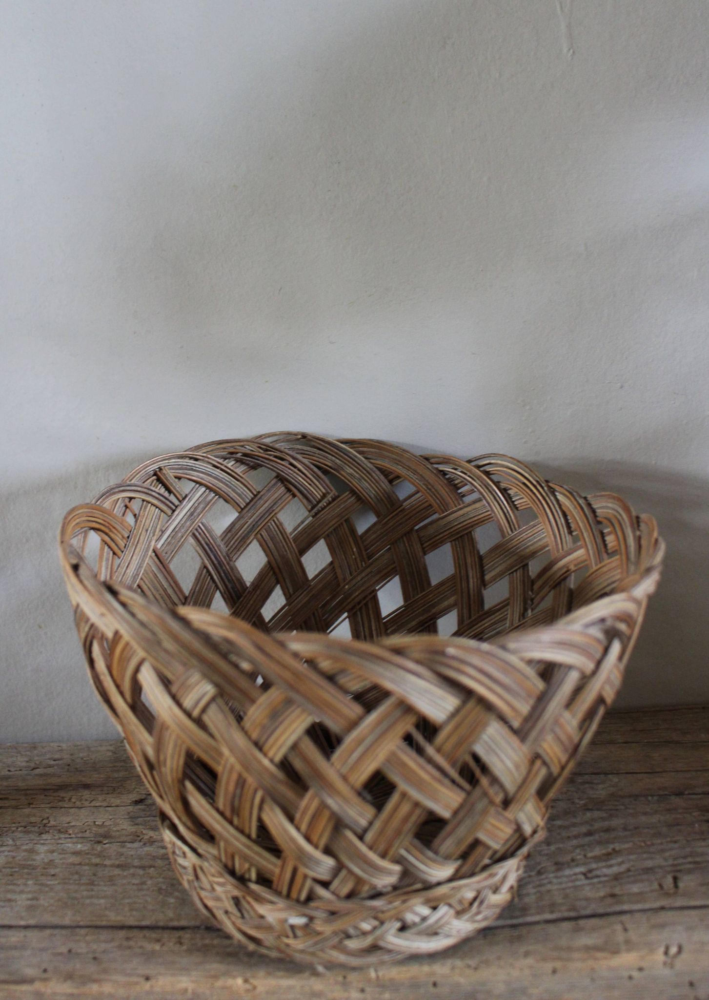 Vintage high round wicker basket with openwork.