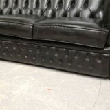 Three-seater black leather chesterfield sofa