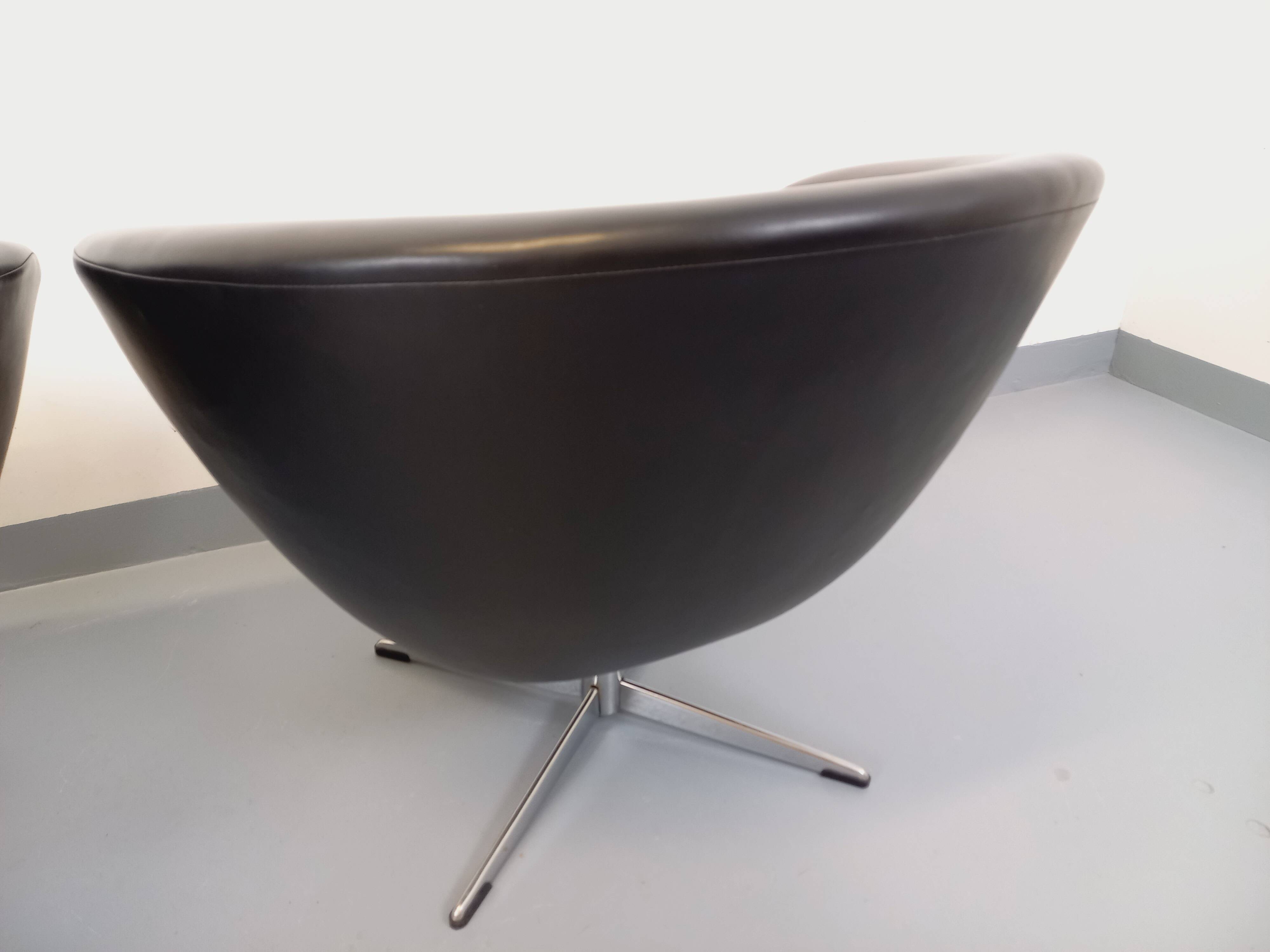 Pair of vintage Scandinavian swivel armchairs in faux leather and chrome.