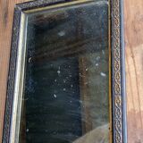 Antique mirror in black and gold wood