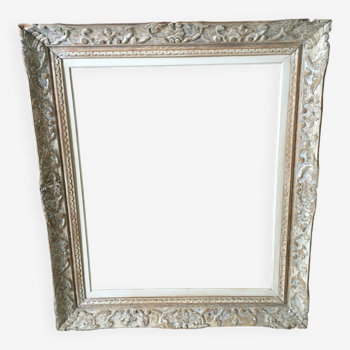 Carved wood frame.