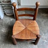 Brutalist low chair in dark wood and straw no. 2