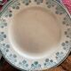 3 flat plates in ironstone with a floral green border.