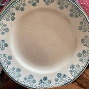 3 flat plates in ironstone with a green floral border
