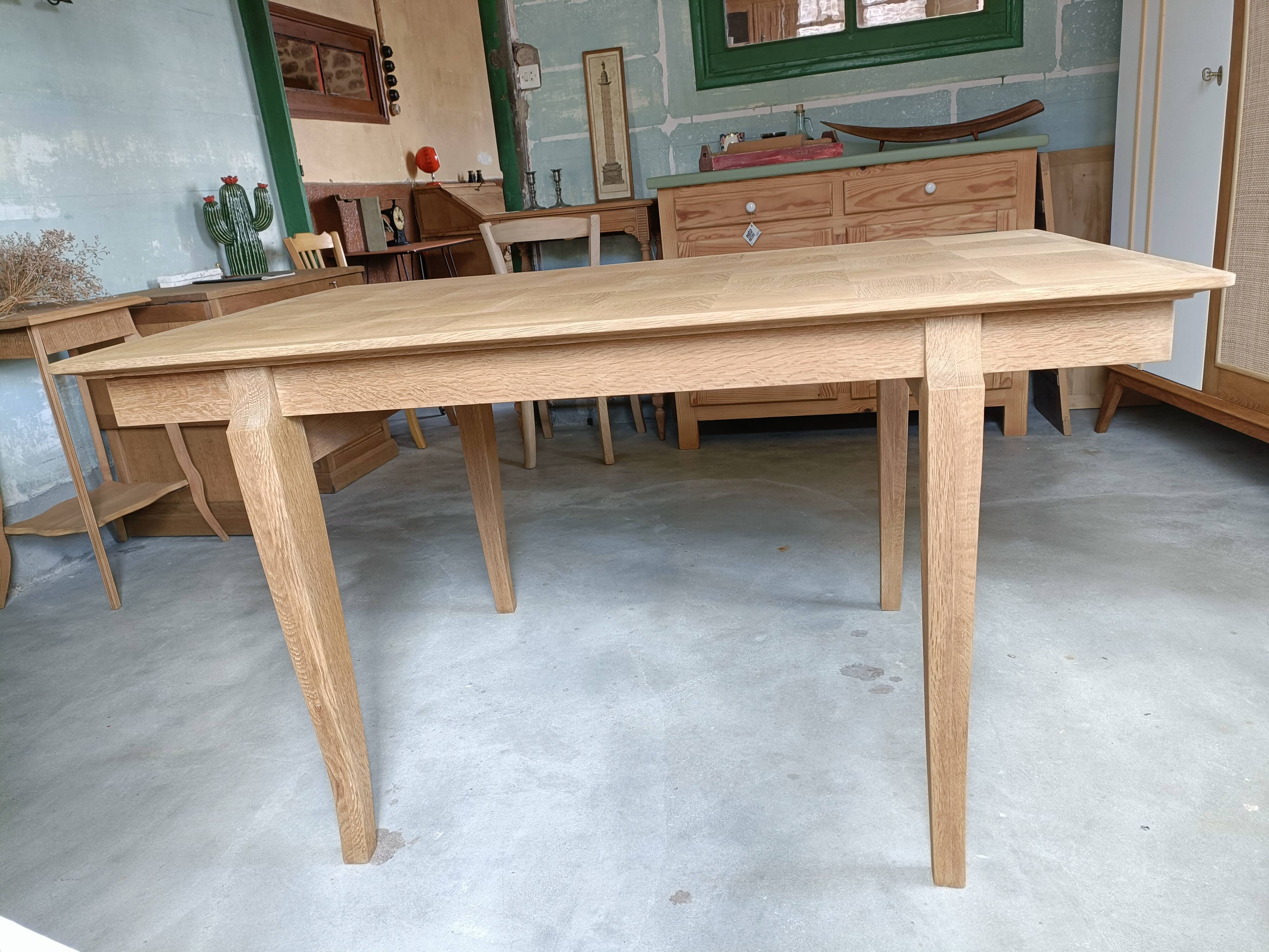 Oak dining table with a checkerboard top and extensions.