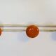 Vintage orange triple coat hook — metal and lacquered discs from the 60s/70s