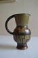 Jug with geometric decoration, signature to be identified.