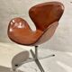 First edition Arne Jacobsen Swan chair, original patinated leather, 1950s