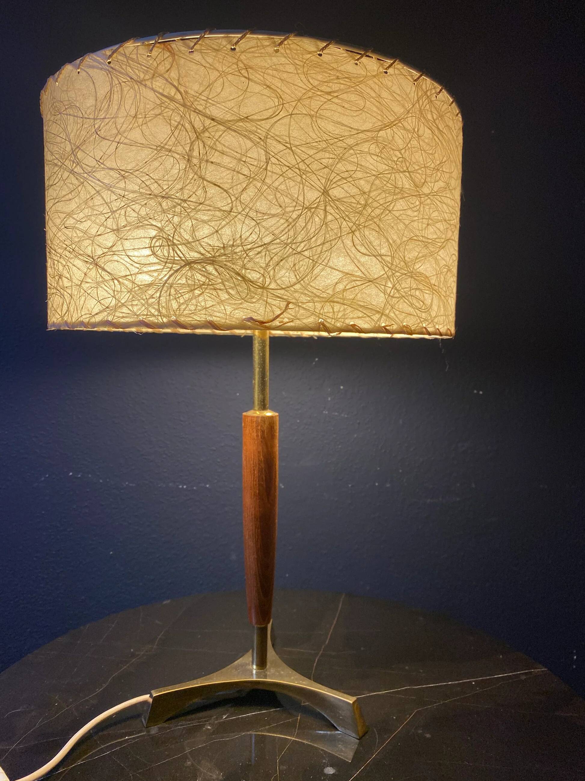 Elegant table lamp with a slender teak body on a tripod brass base, Germany, 1960s.