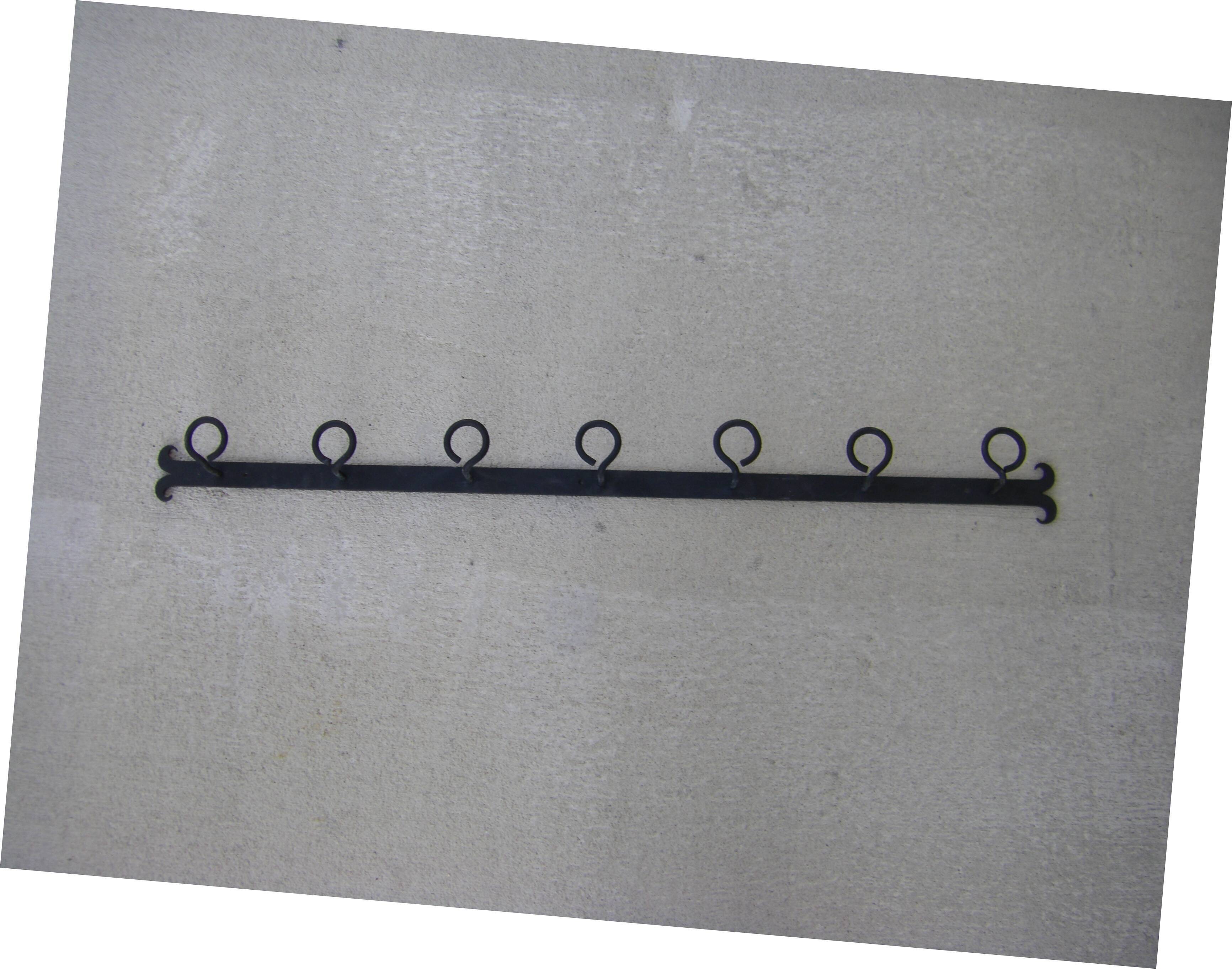 Wall-mounted wrought iron coat racks.