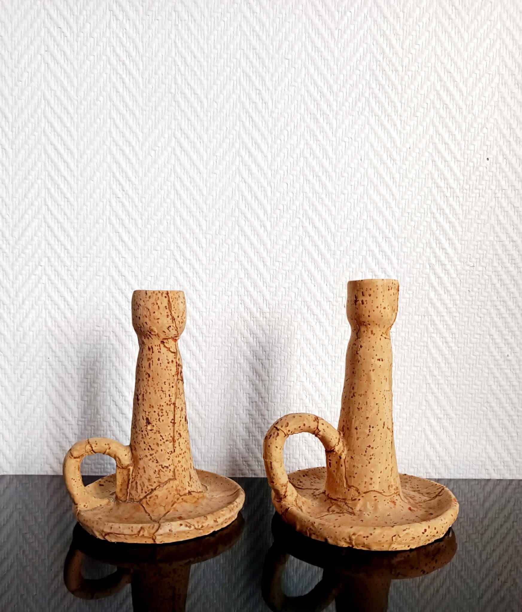 Pair of cork and terracotta candlesticks.