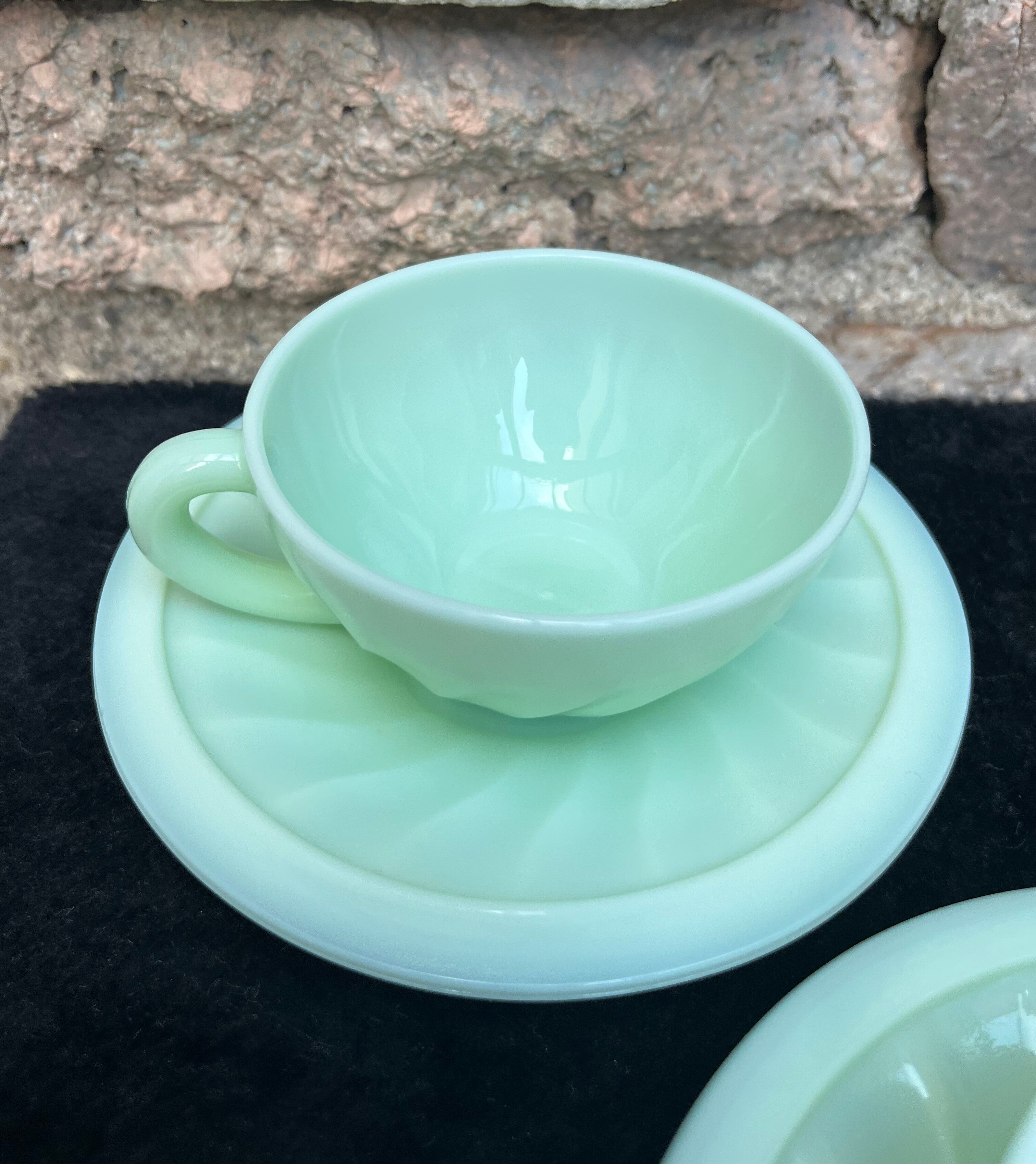 Two green opaline cup and saucer sets.