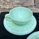 Two green opaline cup and saucer sets.