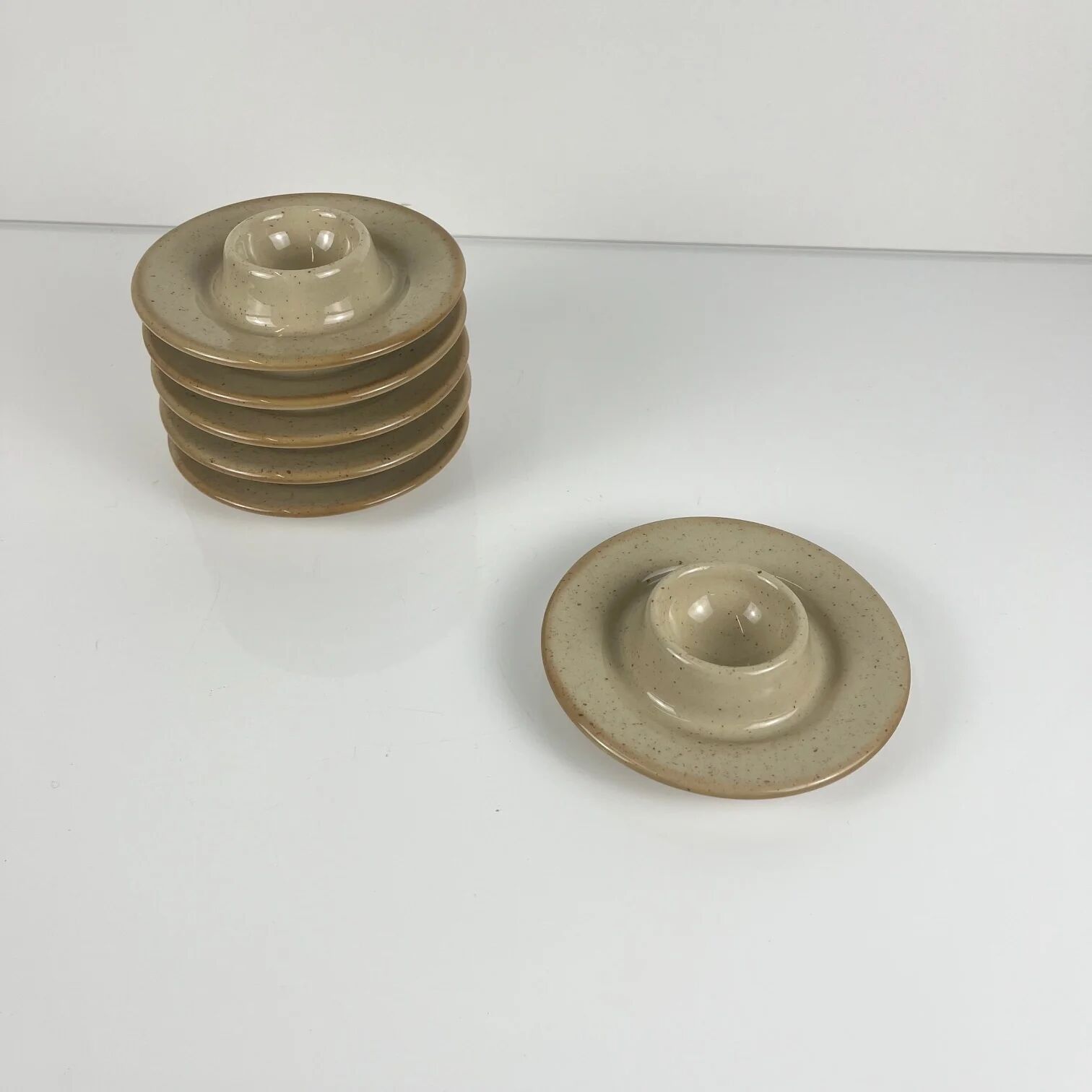 Set of 6 speckled beige ceramic egg cups.