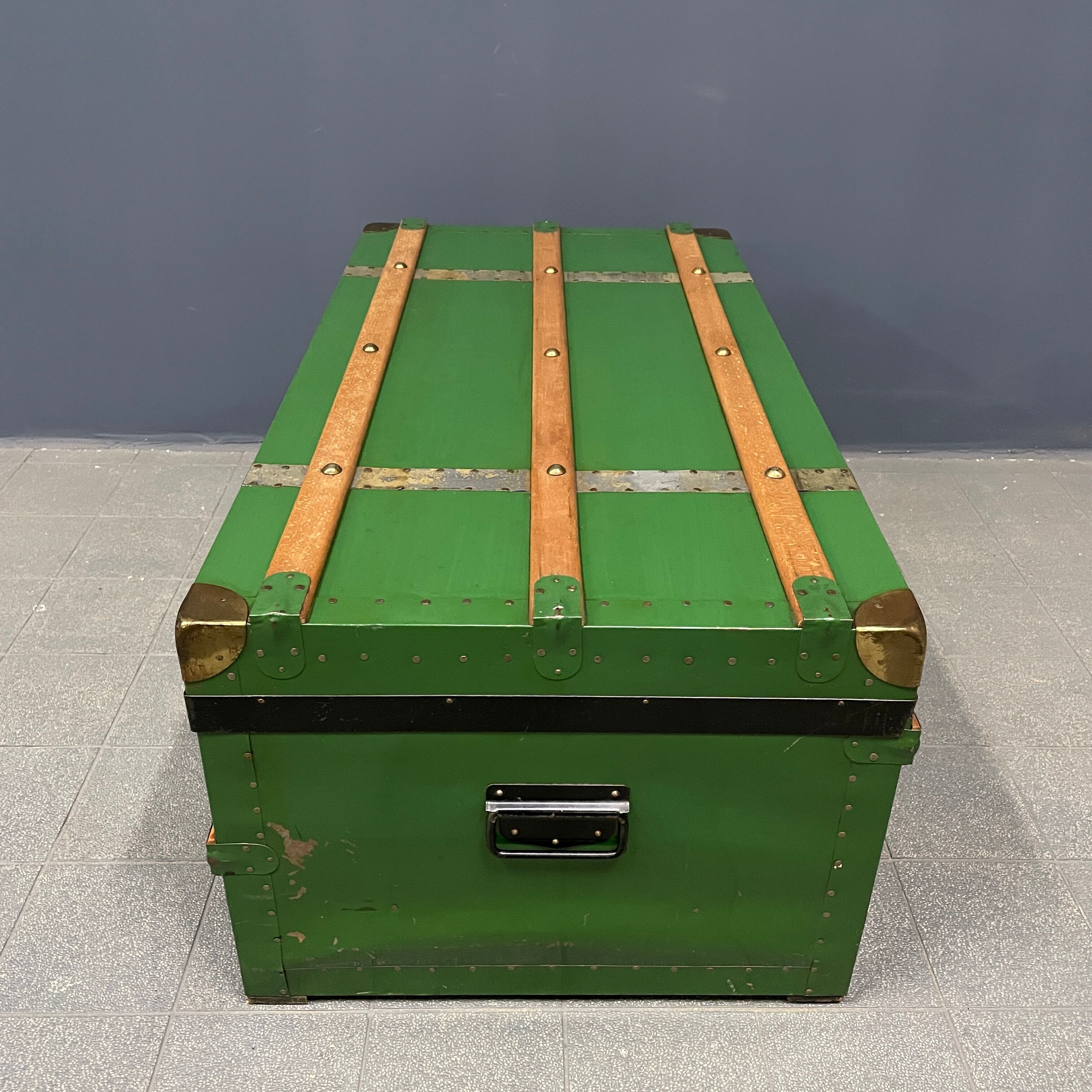 Green metal trunk with wooden sleds