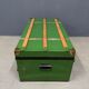 Green metal trunk with wooden sleds