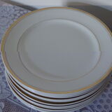 Set of 11 flat white earthenware plates with gold edging
