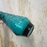 Blue pressed glass bottle decorated with flowers