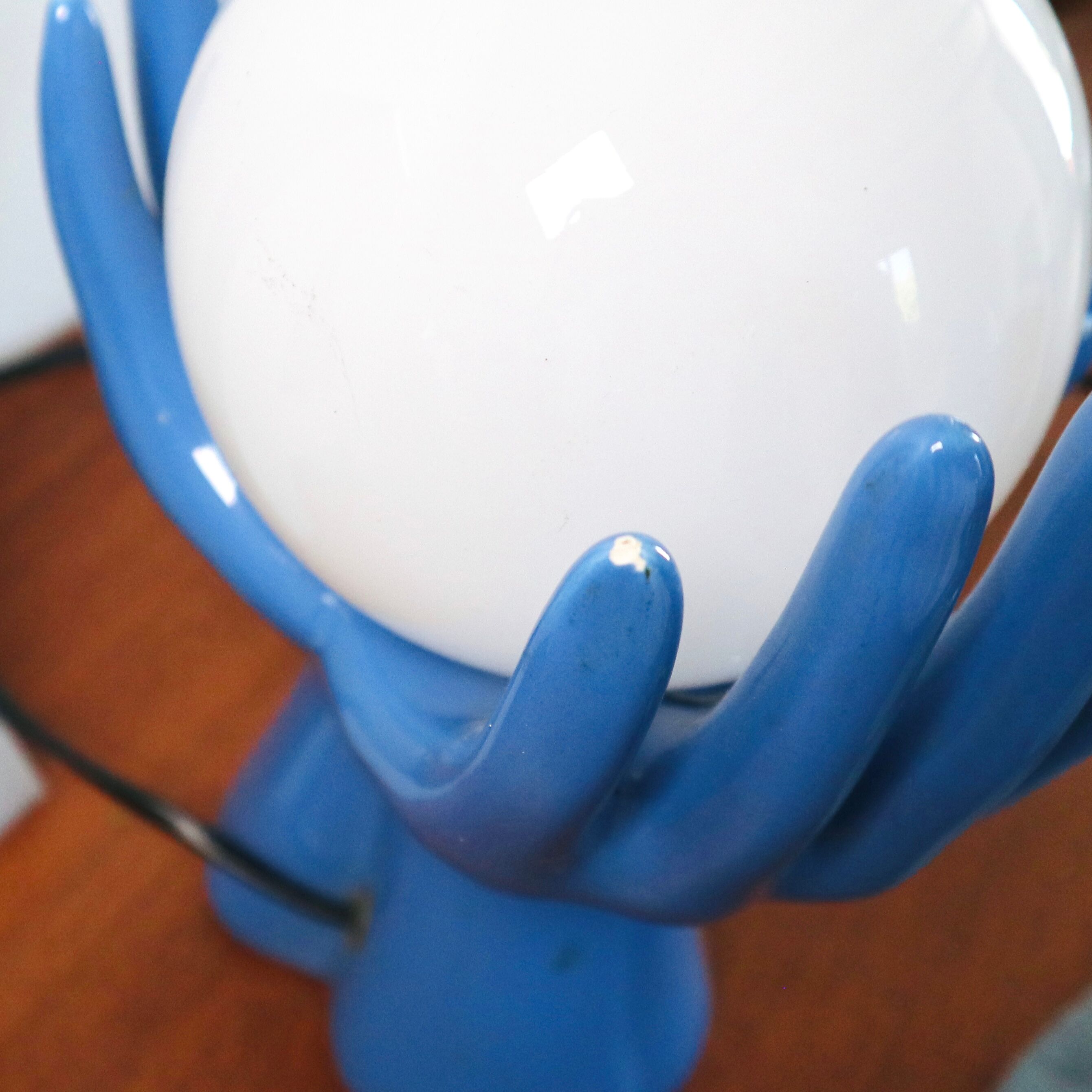 Ceramic lamp hands holding blue globe