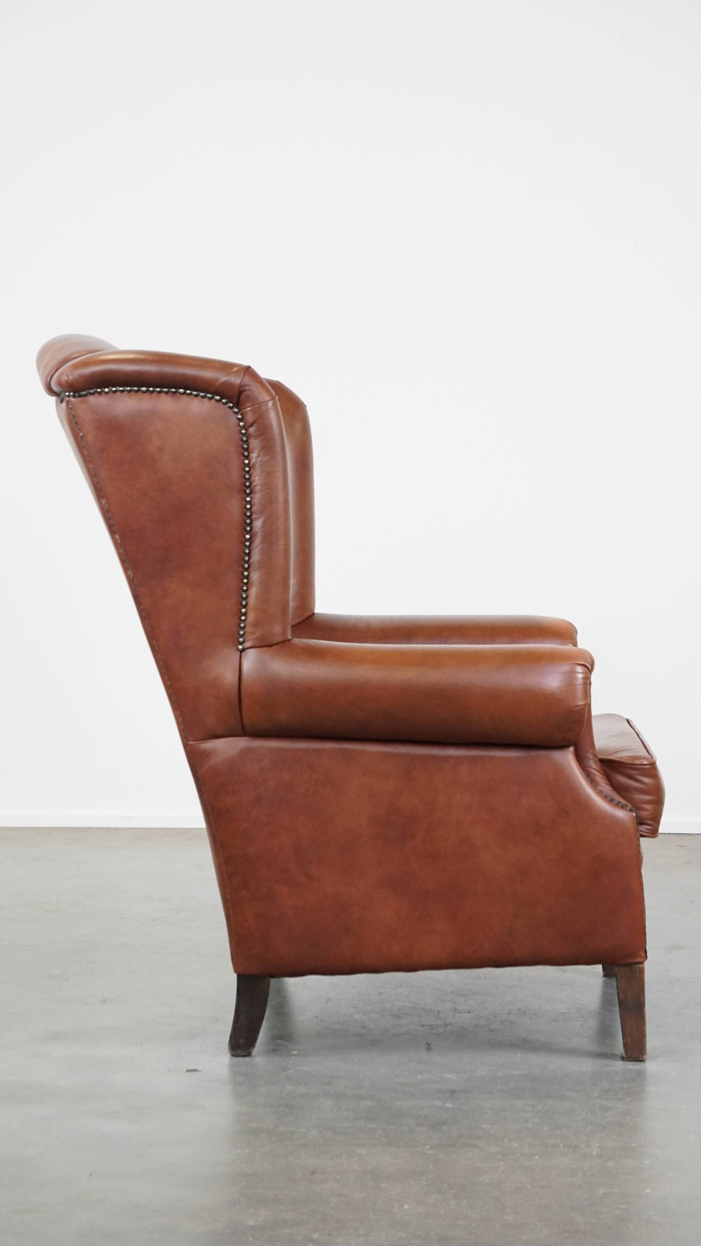Cognac-colored cowhide wingback chair