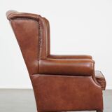 Cognac-colored cowhide wingback chair