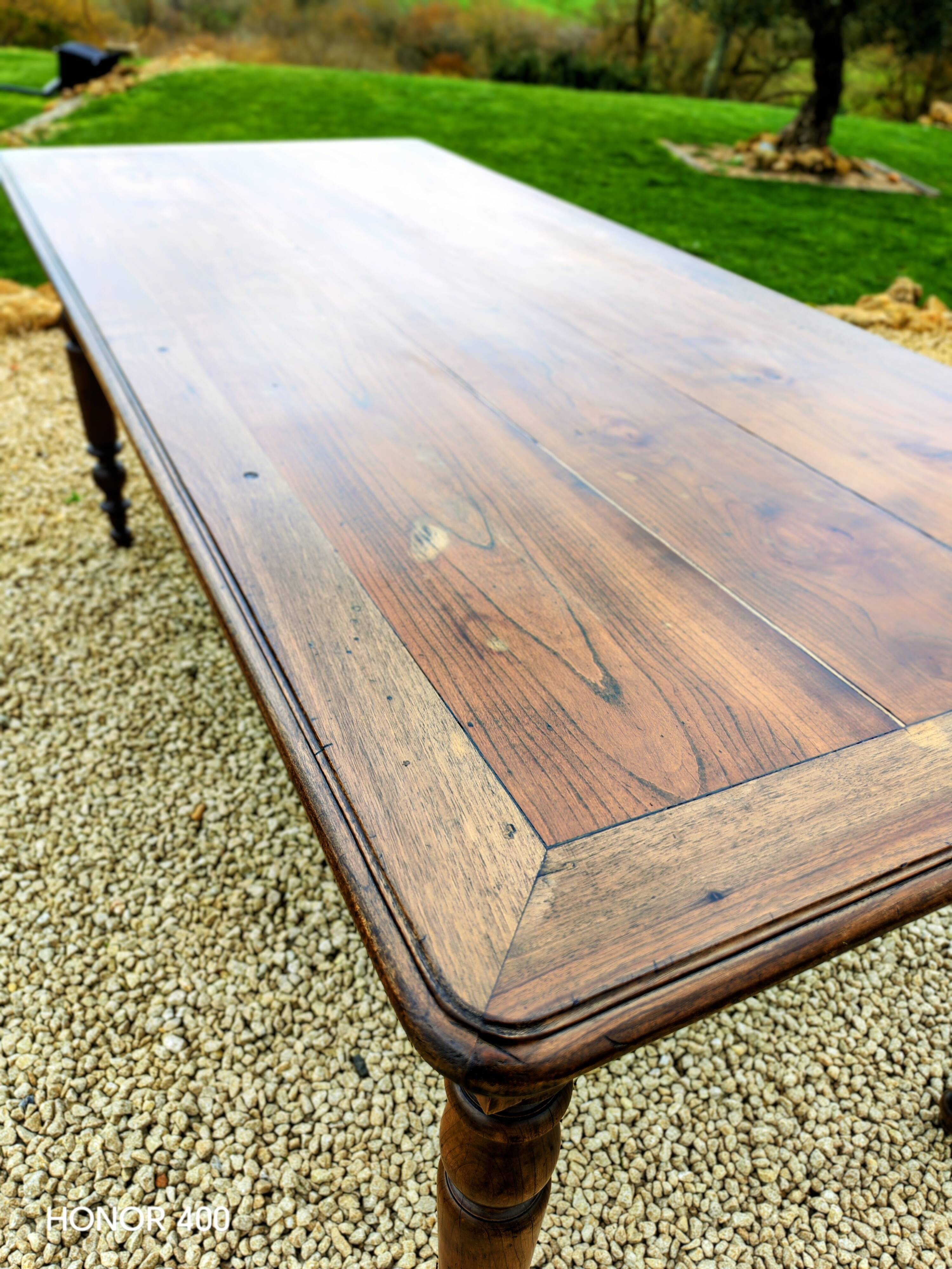 Old French farmhouse table in walnut with turned legs.