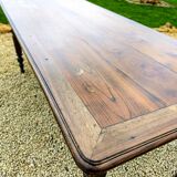 Old French farmhouse table in walnut with turned legs.