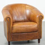 Sheep leather club chair in a cognac color with patina