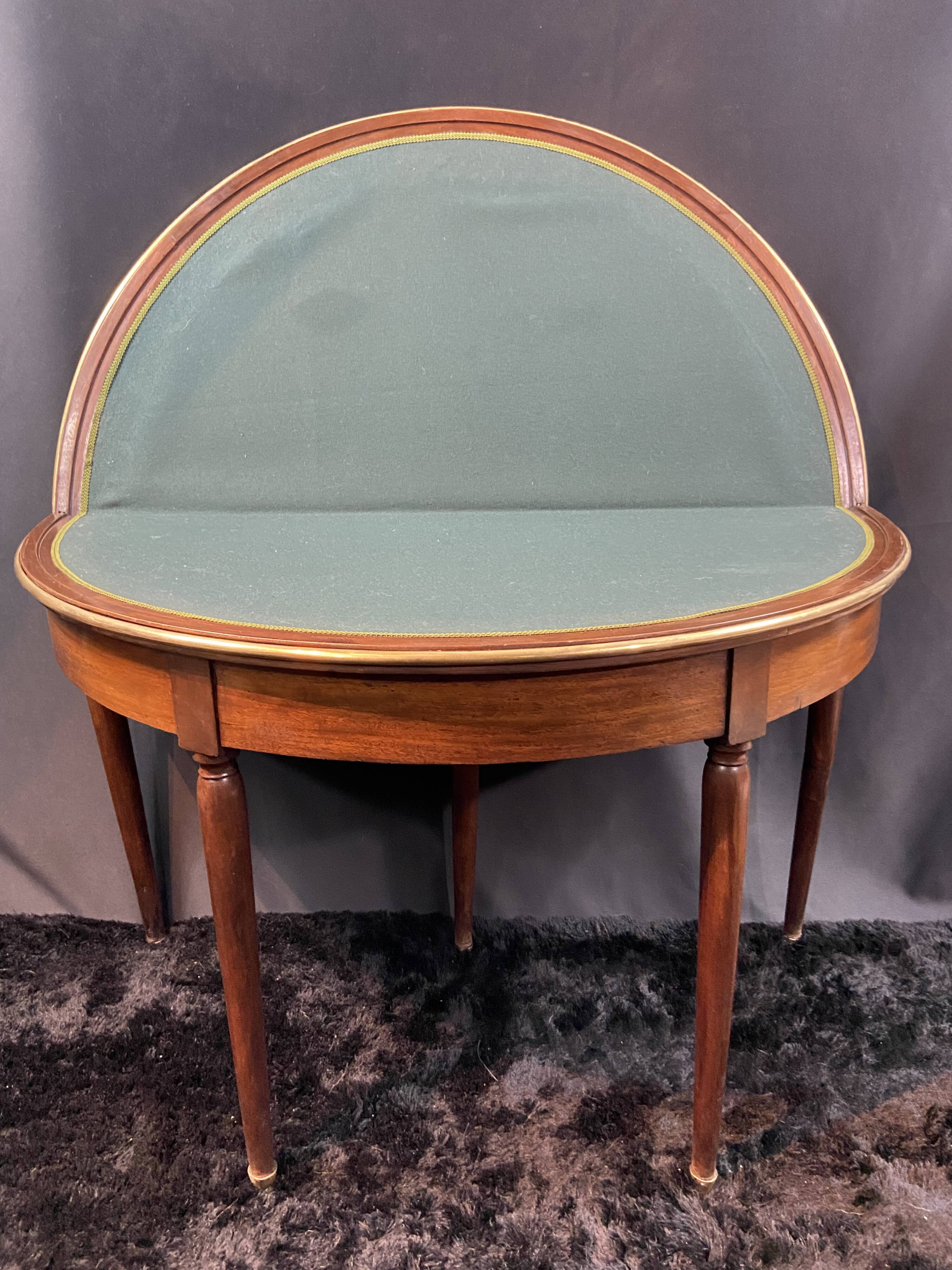 A Louis XVI period mahogany half-moon table forming a console/games table