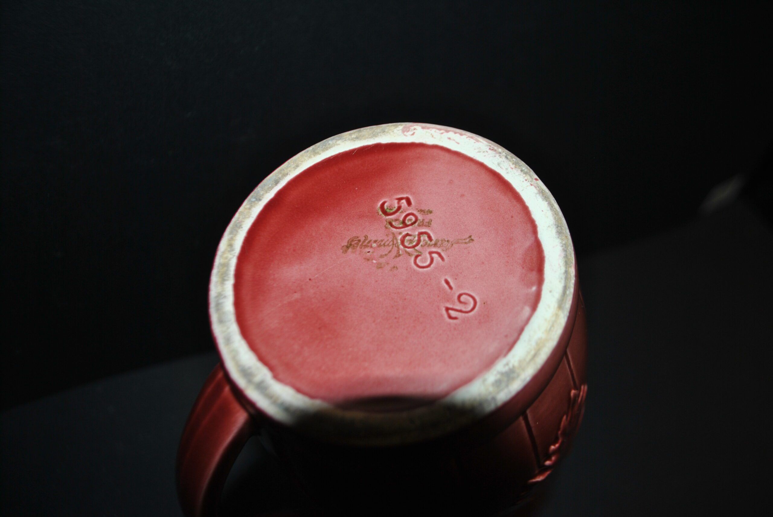 Sarreguemines wine jug in red slipware with grapevine decoration.