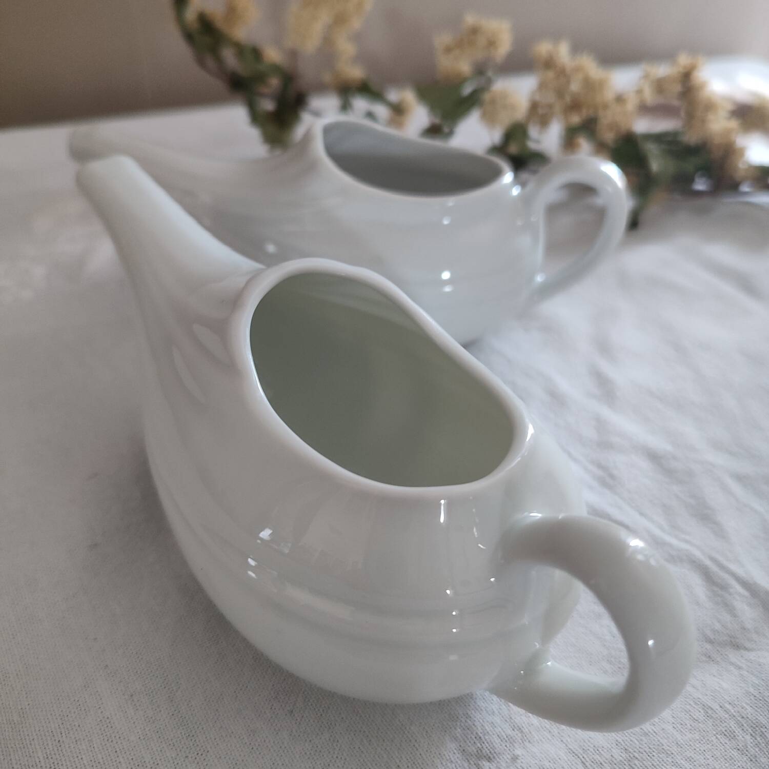 Duo of old white porcelain sauce boats for sick baby bottles