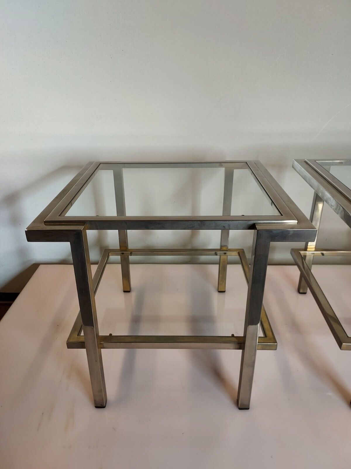 Pair of end of sofas in brushed iron signed Guy Lefevre