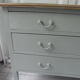 Green green vintage chest of drawers of gray, wood top.